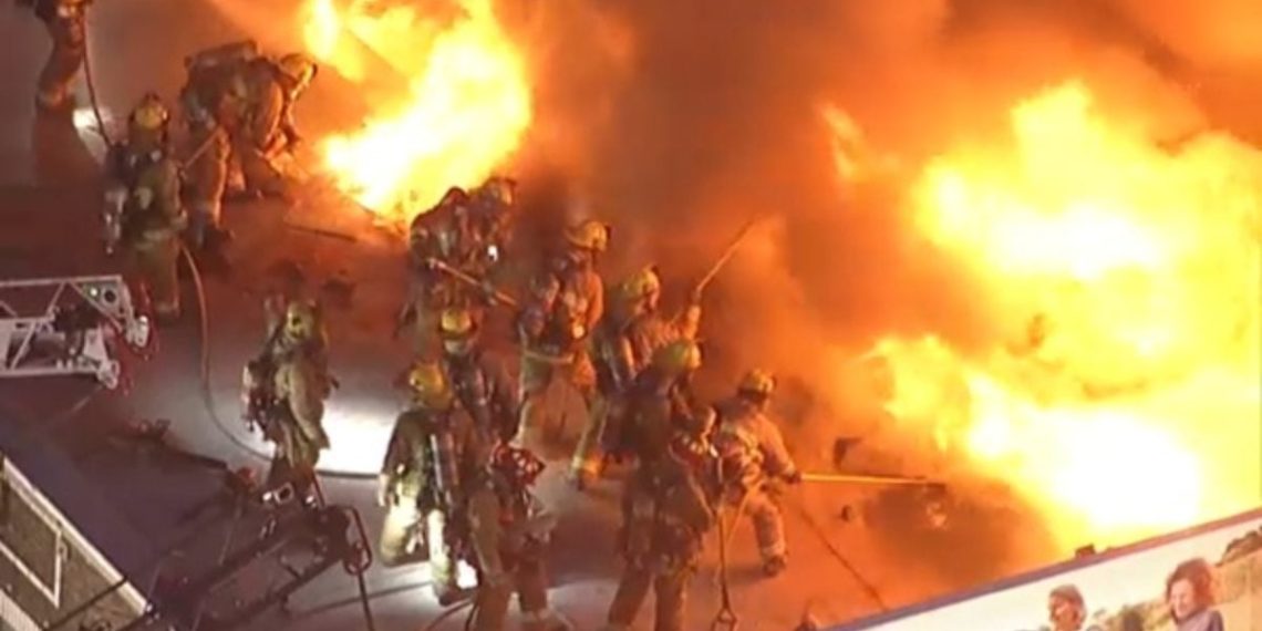 Watch: LA Firefighters Battle Massive Blaze From Roof